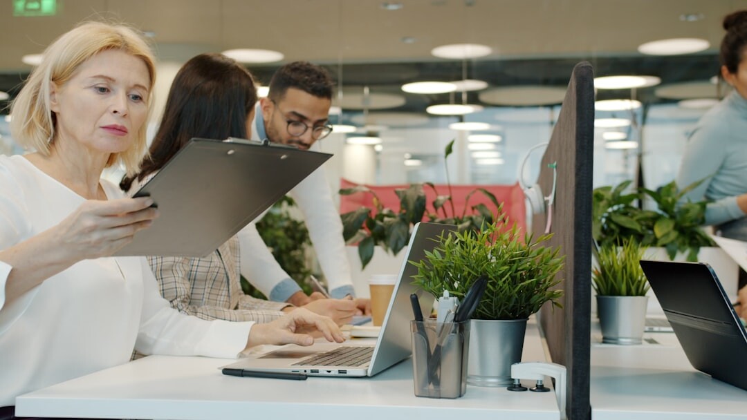 Group of diverse professionals collaborating in a modern tech office