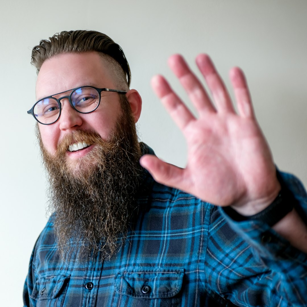 Professional man in his 30s with short beard and casual attire